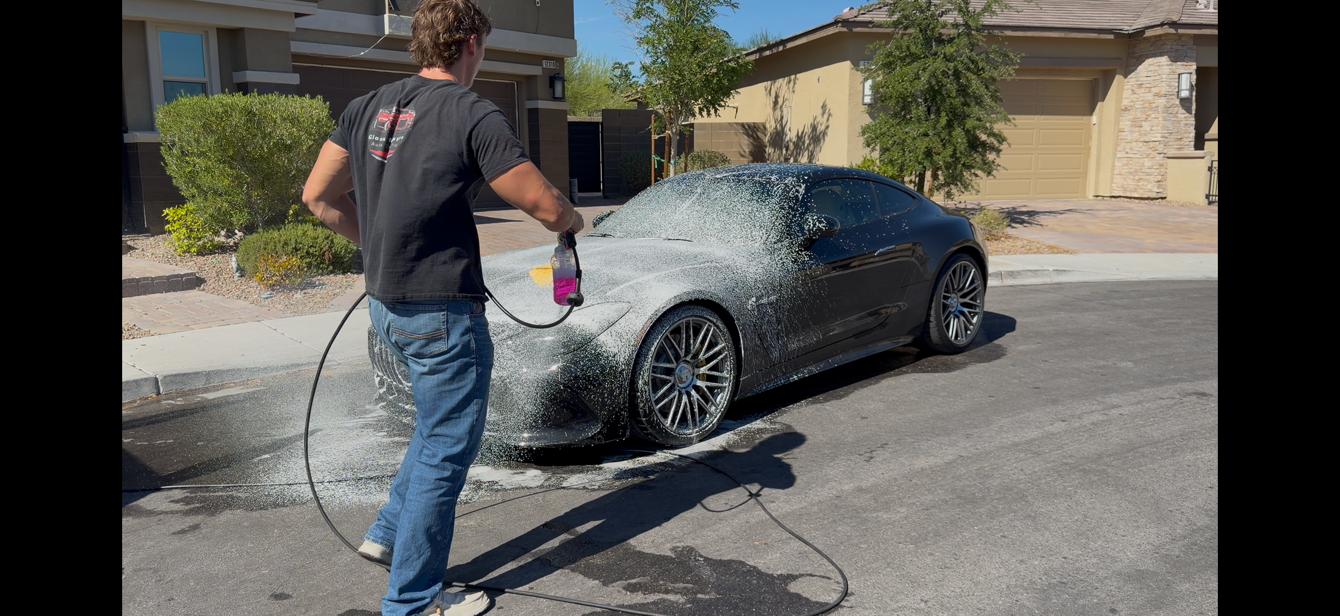 Gloss Masters detailer foam washing a sports car during a full detail in Las Vegas